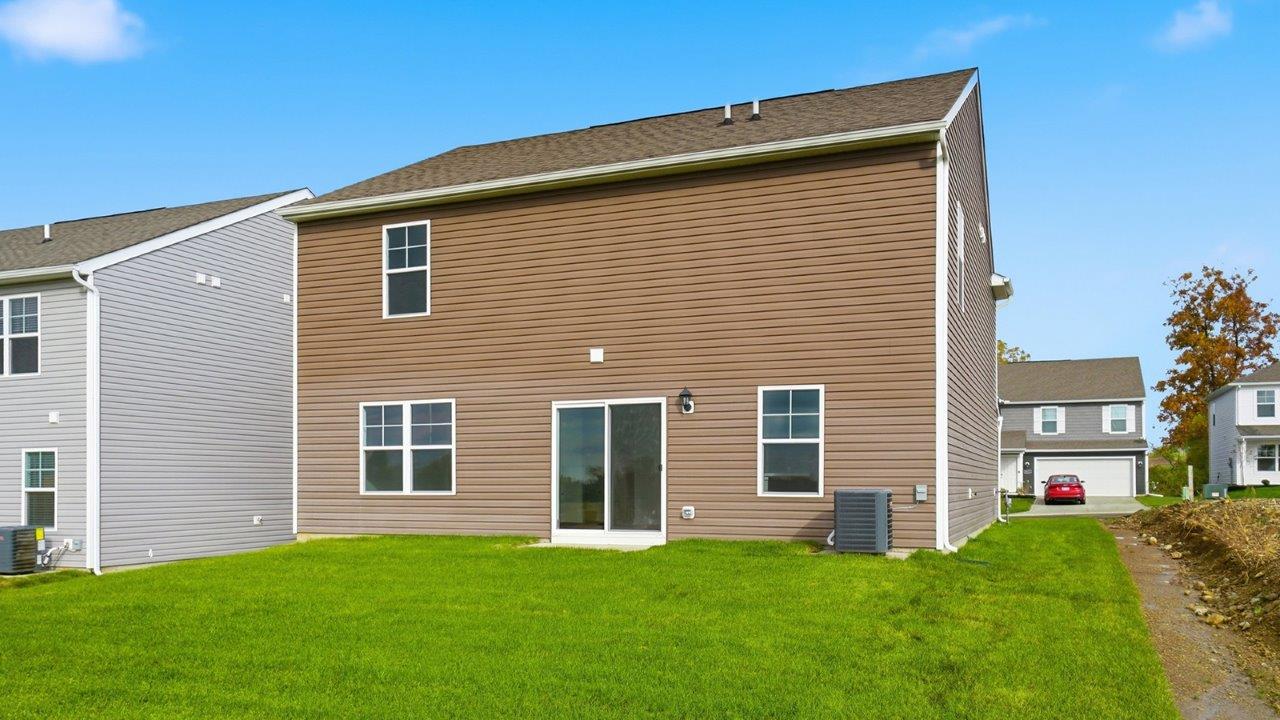 two story home with brown siding rear exterior