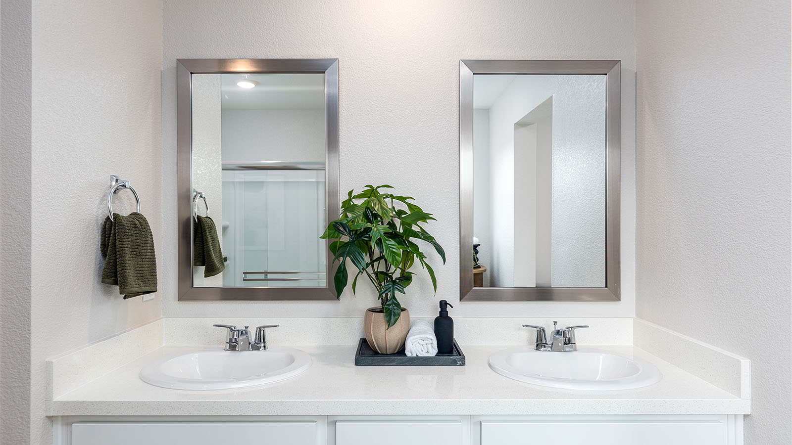 Montego Plan 2311  spa inspired  primary bathroom with dual sinks and a walk in shower
