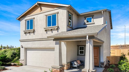 Amber Lynn Estates Plan 1678 Two-story home with light tan exterior and a covered porch and two-car garage.
