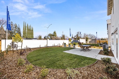 Amber Lynn Estates Plan 1547 Backyard patio and lawn with landscaping and soundwall.