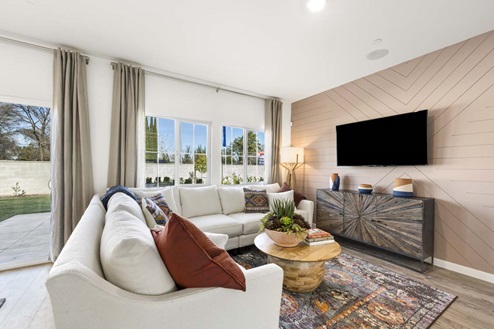 Amber Lynn Estates Plan 1547 Living room with side-by-side paned windows and full-length curtains.