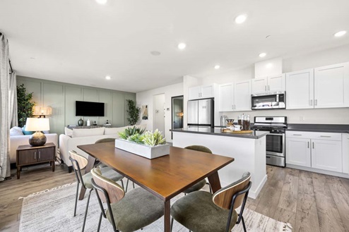 Amber Lynn Estates Plan 1811 Modern open-concept living and dining area with view of kitchen and living room.