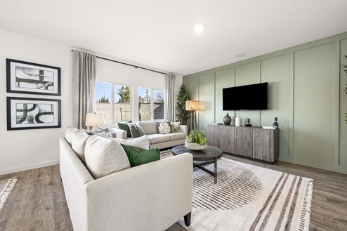 Amber Lynn Estates Plan 1811 Living room with side-by-side windows and sage green wall.
