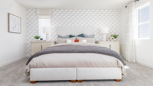 Spacious primary bedroom with large paned windows
