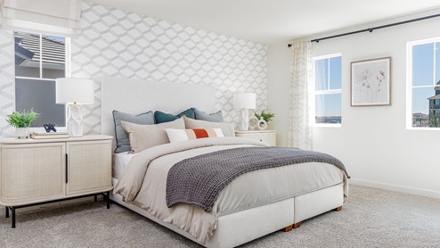 Spacious primary bedroom with large paned windows
