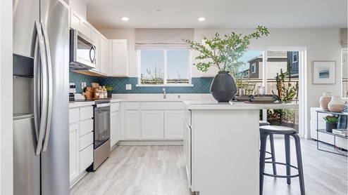 Modern kitchen with quartz countertops and stainless steel appliances