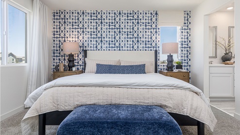 Spacious primary bedroom with large paned windows