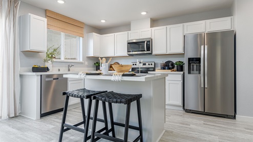 Modern kitchen with quartz countertops and stainless steel appliances