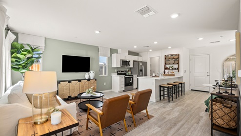 Spacious living area with window and floor length curtains