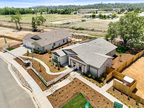 Aerial view of two single story homes