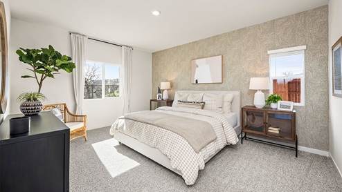 Spacious primary bedroom with large paned windows