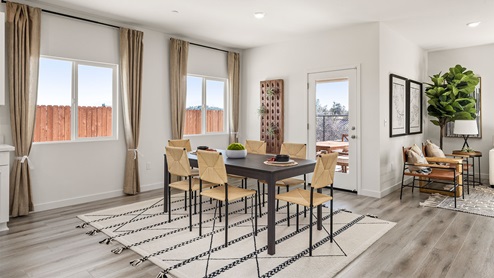 Open concept dining area with paned windows and door to back patio