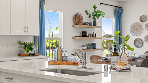 Open countertop space on kitchen island with stainless steel sink