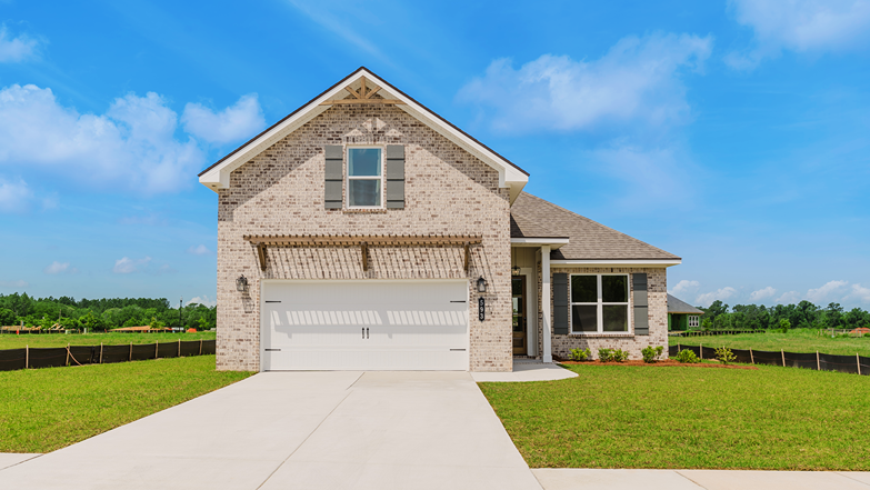 Two-story home with brick exterior and board and batten accents.