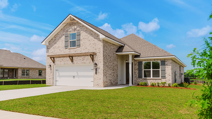 Two-story home with brick exterior and board and batten accents.