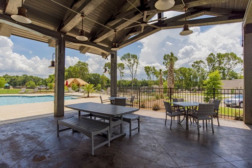 Covered pavillion at Old Battles Village with seating overlooking pool.