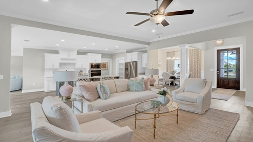 View of living room to kitchen with modern and bright open concept.