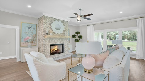 Open concept living room with light walls and wooden floors.