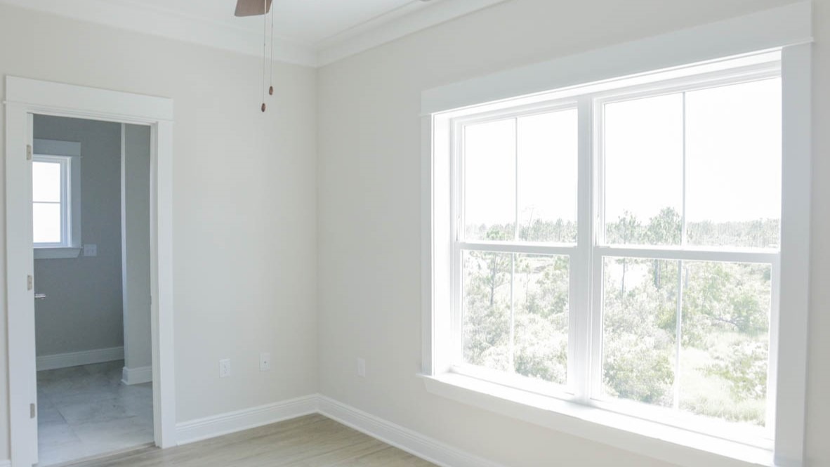 Primary bedroom with a large window and en suite bathroom.