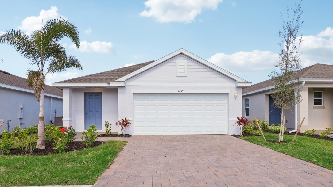 Outside of the Downing II. Home with paver driveway with 2 car garage.