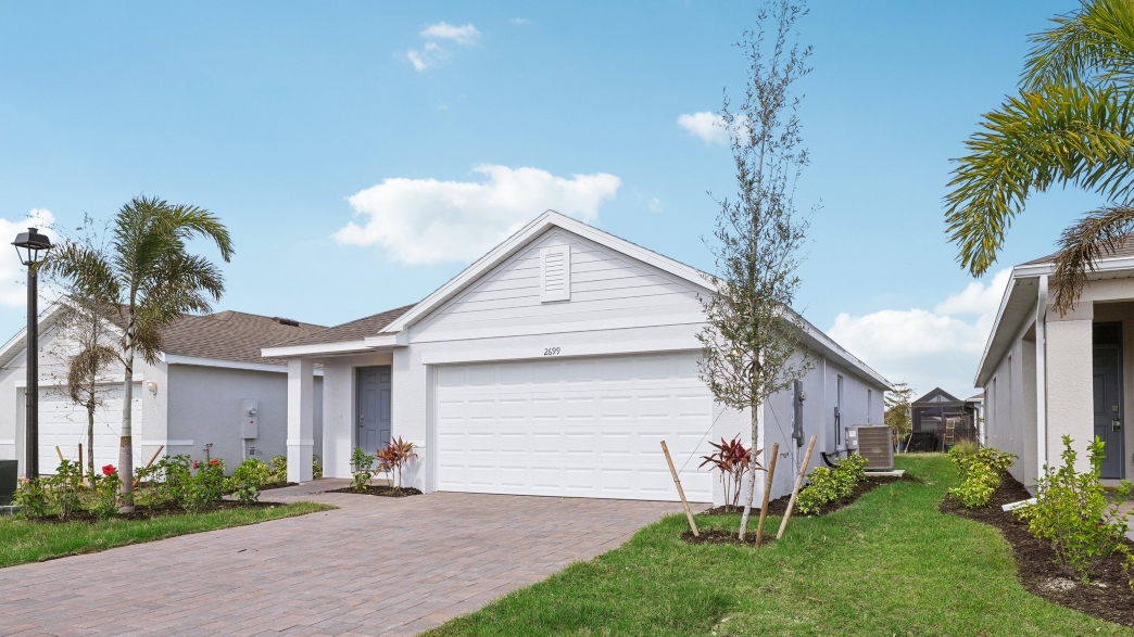 Outside of the Downing II. Home with paver driveway with 2 car garage.