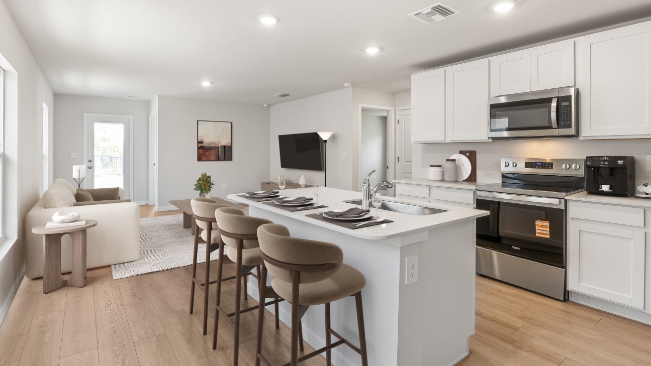 Inside of the kitchen. Stainless steel appliances, quartz countertops, walk-in corner pantry.