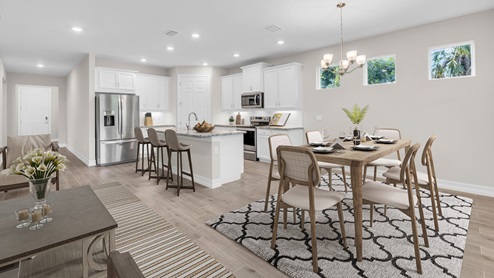 Inside of the Delray B model kitchen and dining area. This photo demonstrates how the kitchen and dining space open up to the living area and hallway that leads to the front door.