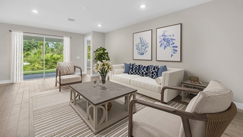 Inside of the Delray B model. This photo of the living area demonstrates how the living area opens up to a bedroom as well as the sliding glass door to the back patio.