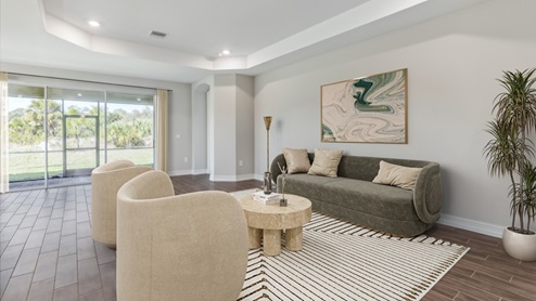 Inside of the Shelby model living area. This photo shows the sliding glass door that leads to the back patio as well as a door to a bedroom.