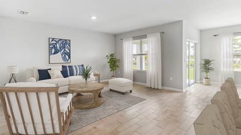 Inside of the Aria living room. This photo demonstrates that the living area connects to the back patio.