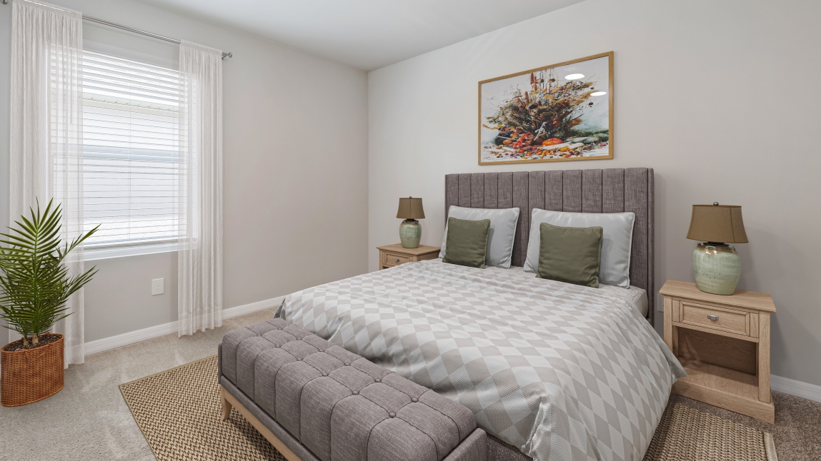Inside the fourth bedroom of the Lakeside. Carpetted floors and gray walls with Farmhouse style décor. There is a window for viewing the landscaped area outside.