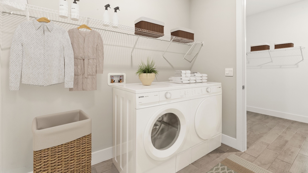 Inside of the Shelby model laundry room. Washer and Dryer space with racks to store cleaning supplies