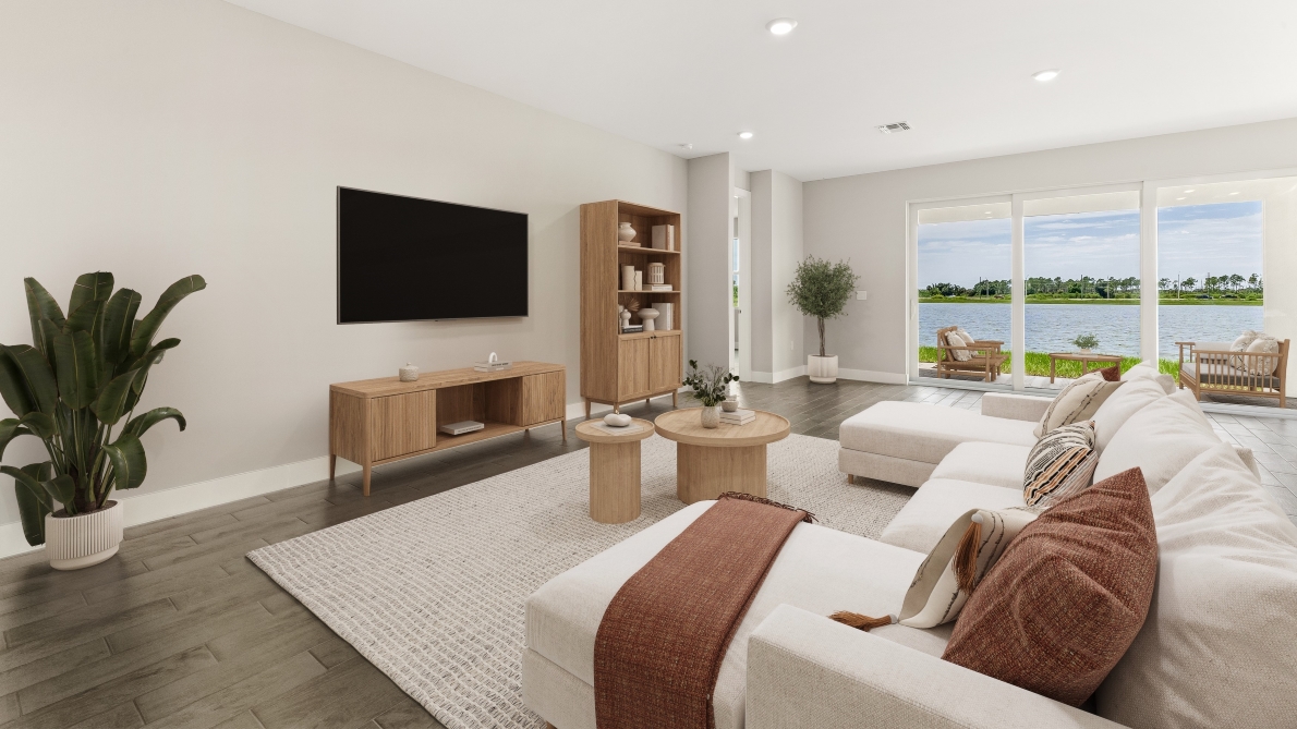 Inside of the Shelby model home living room with tv, bookshelf, couch and coffee table.