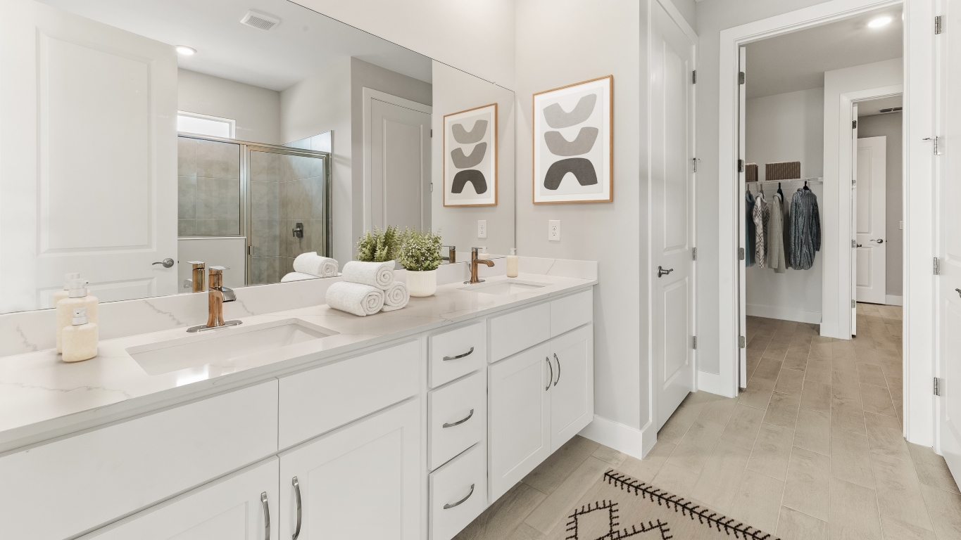 Inside of the Shelby primary bathroom. Dual vanity sinks. The bathroom is connected to the walk in closet.