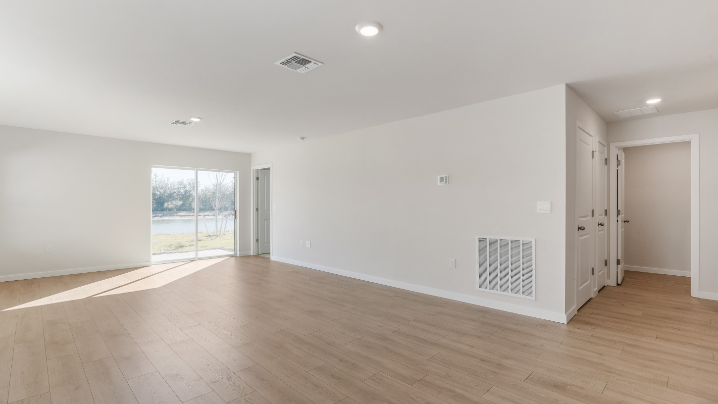 Inside of the Cameron B model living area. Revwood floors and white walls.