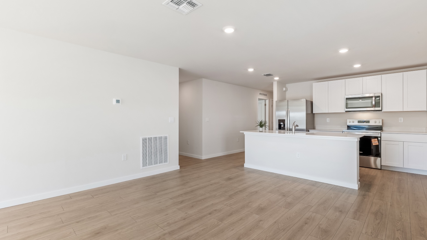 Inside of the Cameron B model living area. Revwood floors and white walls.