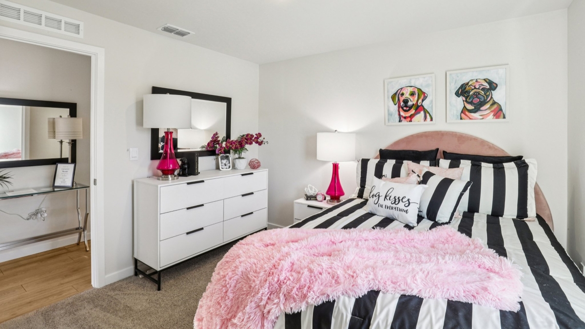 Inside of the Cameron B model bedroom. Off-white carpet with white walls.