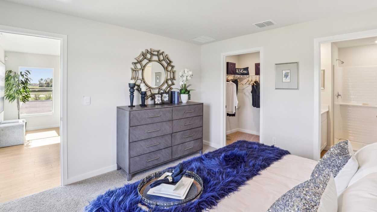 Inside of the Cameron B model bedroom. Off-white carpet with white walls.