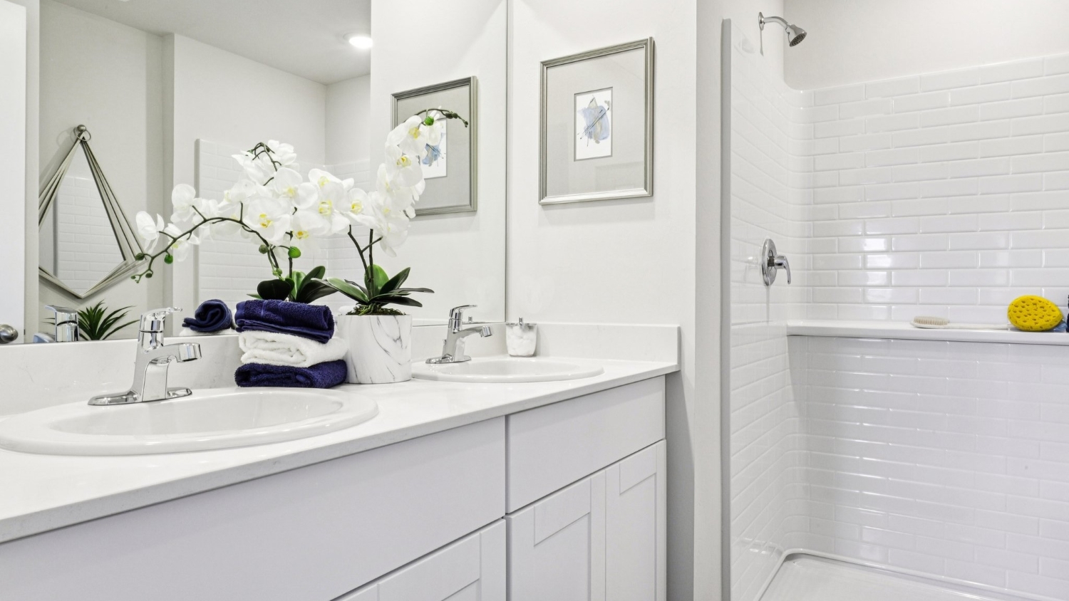 Inside the Cameron model bathroom. White countertops and cabinets. Dual vanity sink.