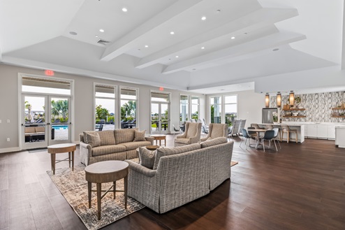 Inside of the amenity center with seats, tables, and couches
