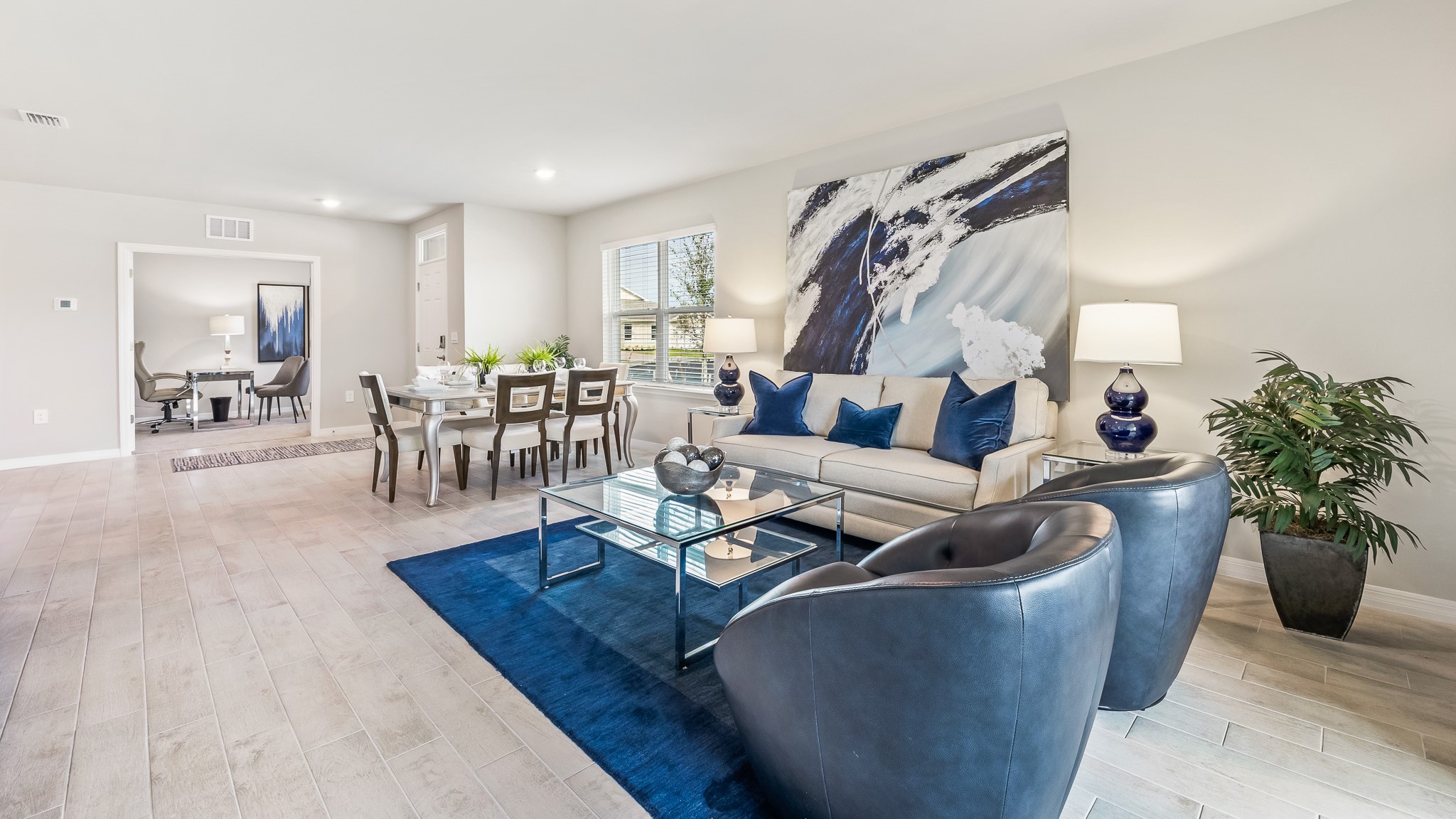 Inside the Carrington Model living room, you can see to the dining area and den/study from across the living space.