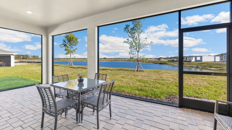 Inside the Lantana model patio. Screened in Lanai patio. Table with seating for 4.