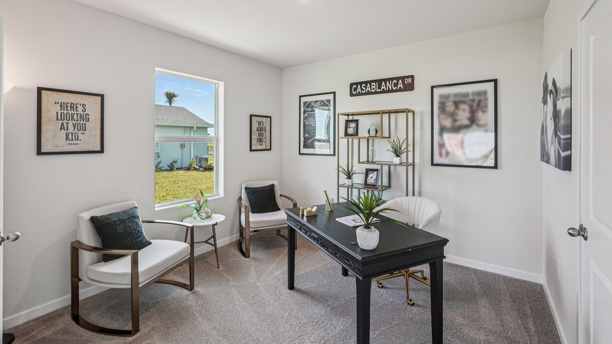 Inside the Carrington den. Small desk with two side chairs and side table.