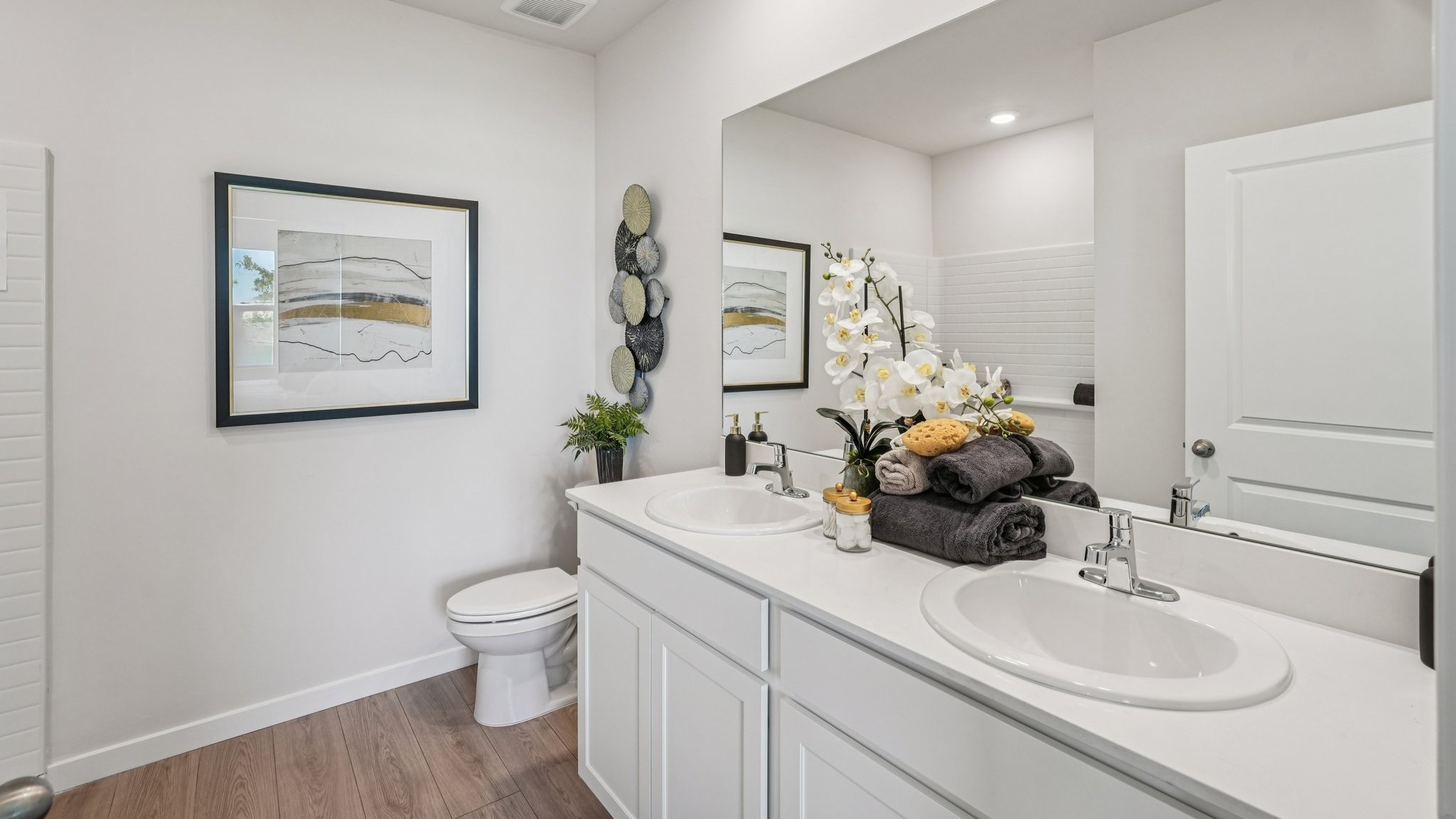 Inside bathroom 2 of the carrington model. White cabinets and counters.