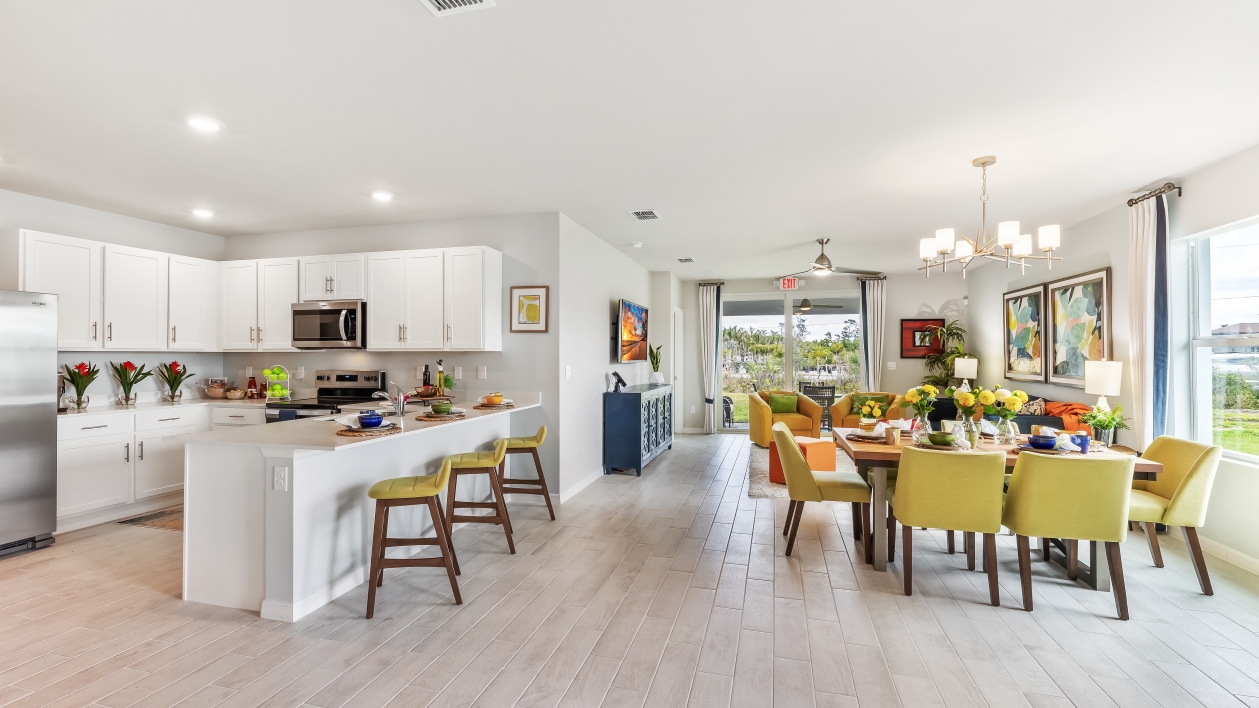 Open concept great room featuring the kitchen, dining area, and living room.
