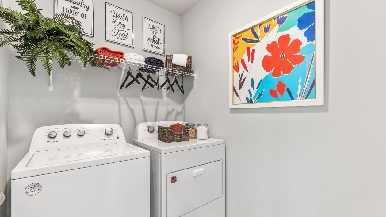 Laundry room with shelving and washer and dryer.