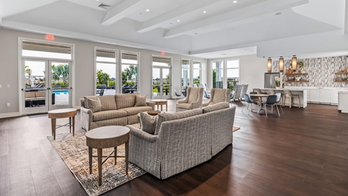 Inside of the amenity center with seats, tables, and couches