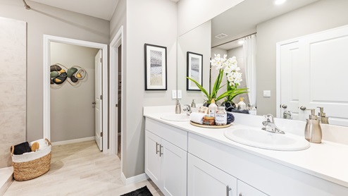 This is the Lakeside's master bathroom, The shower is tiled without a tub and and the dual sinks have silver fixtures. You can also access the master closet through here.