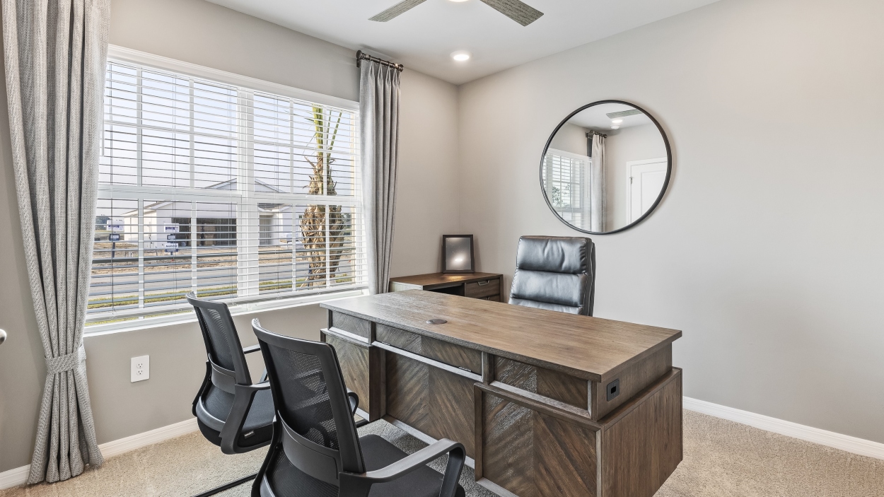 This is the Lakeside's bonus room. Creme carpet with grey walls, and a desk with two chairs.