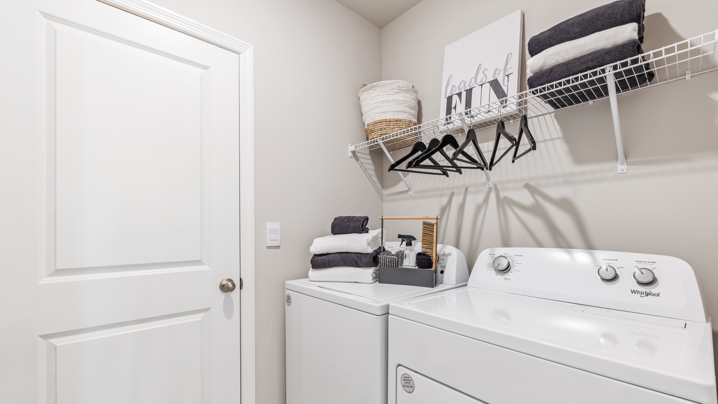 This is the Lakeside's laundry room. Washer and dryer with hanger storage above.